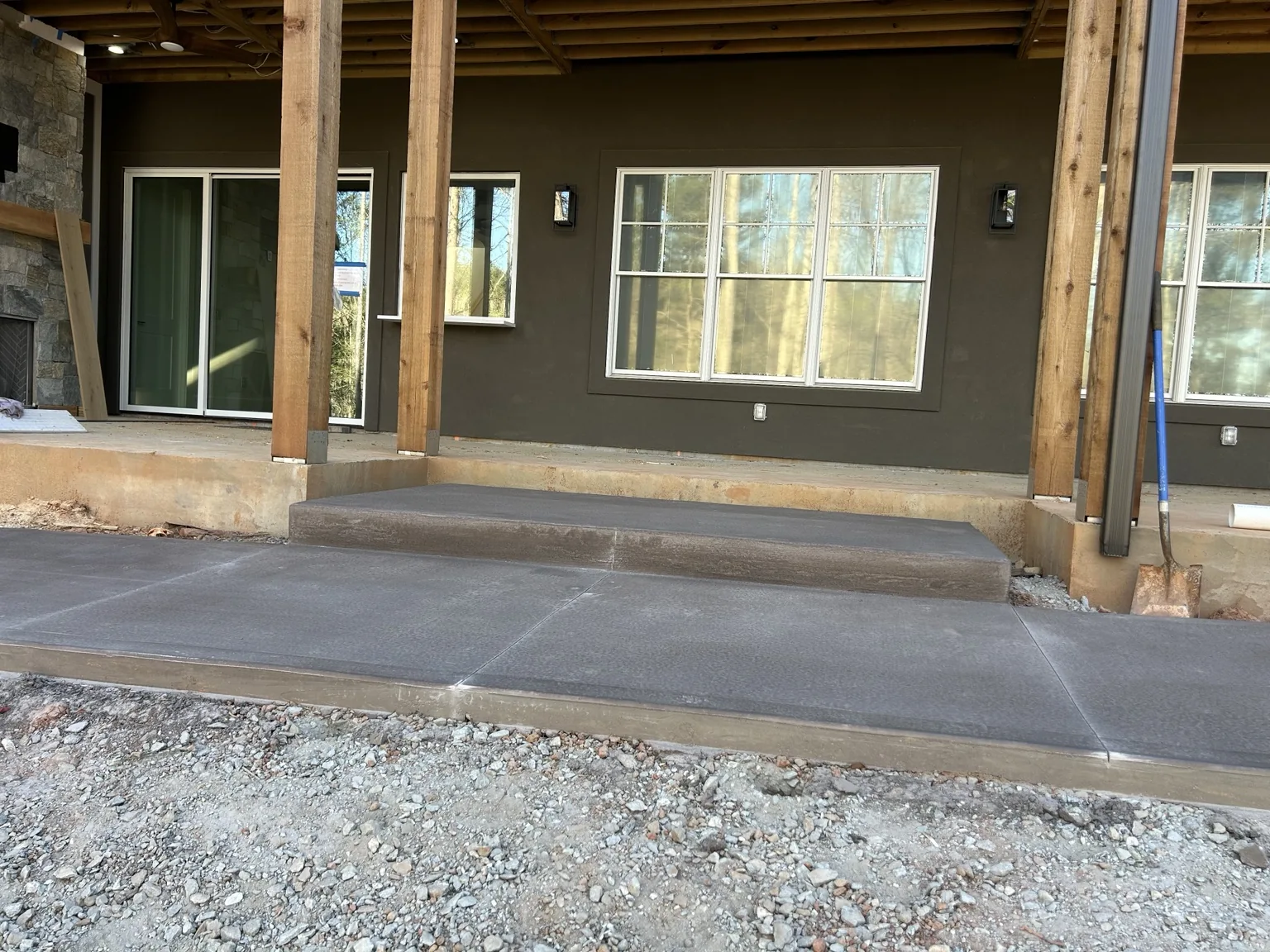 Concrete beneath a covered porch
