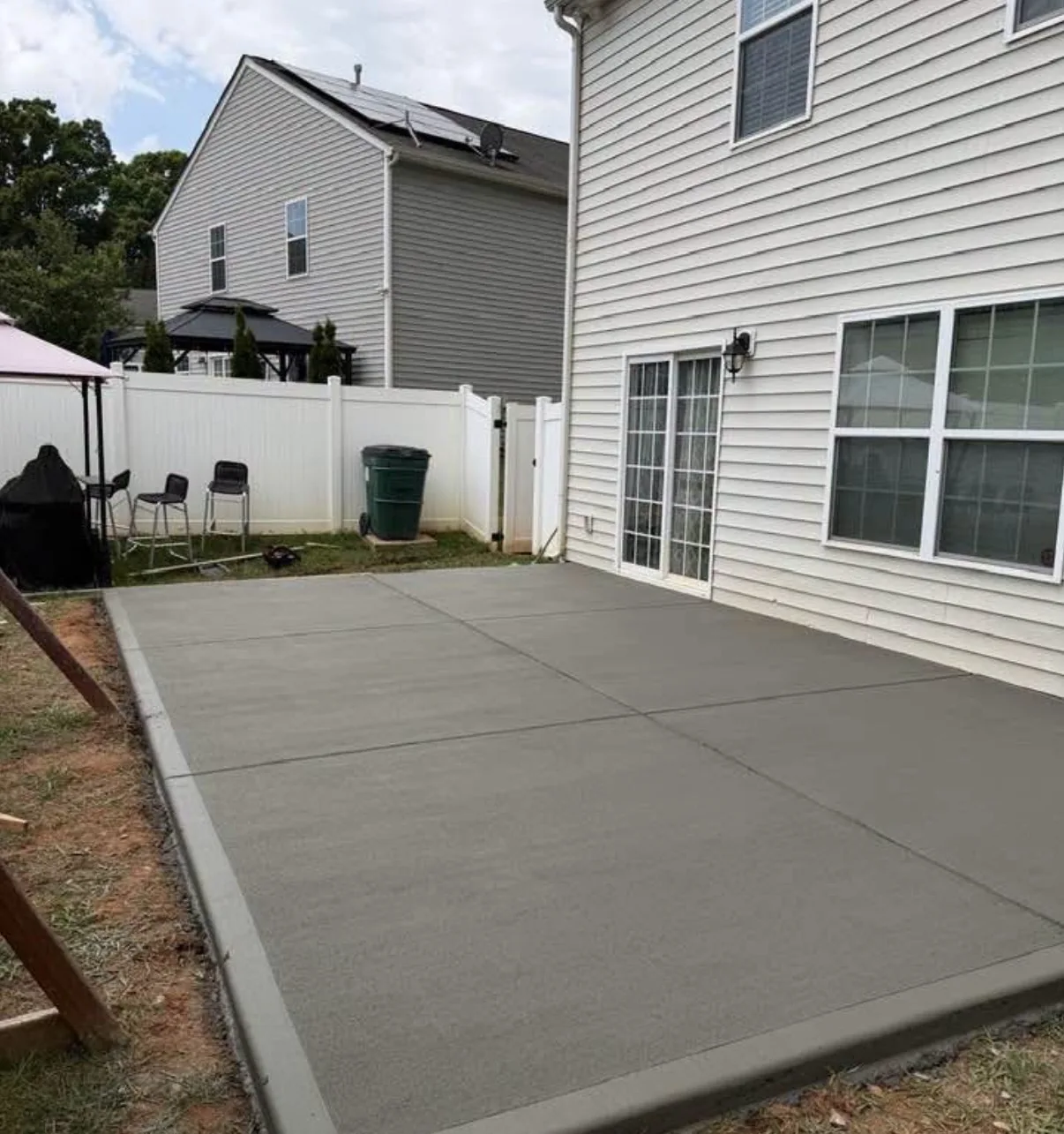 Large concrete patio beside the house