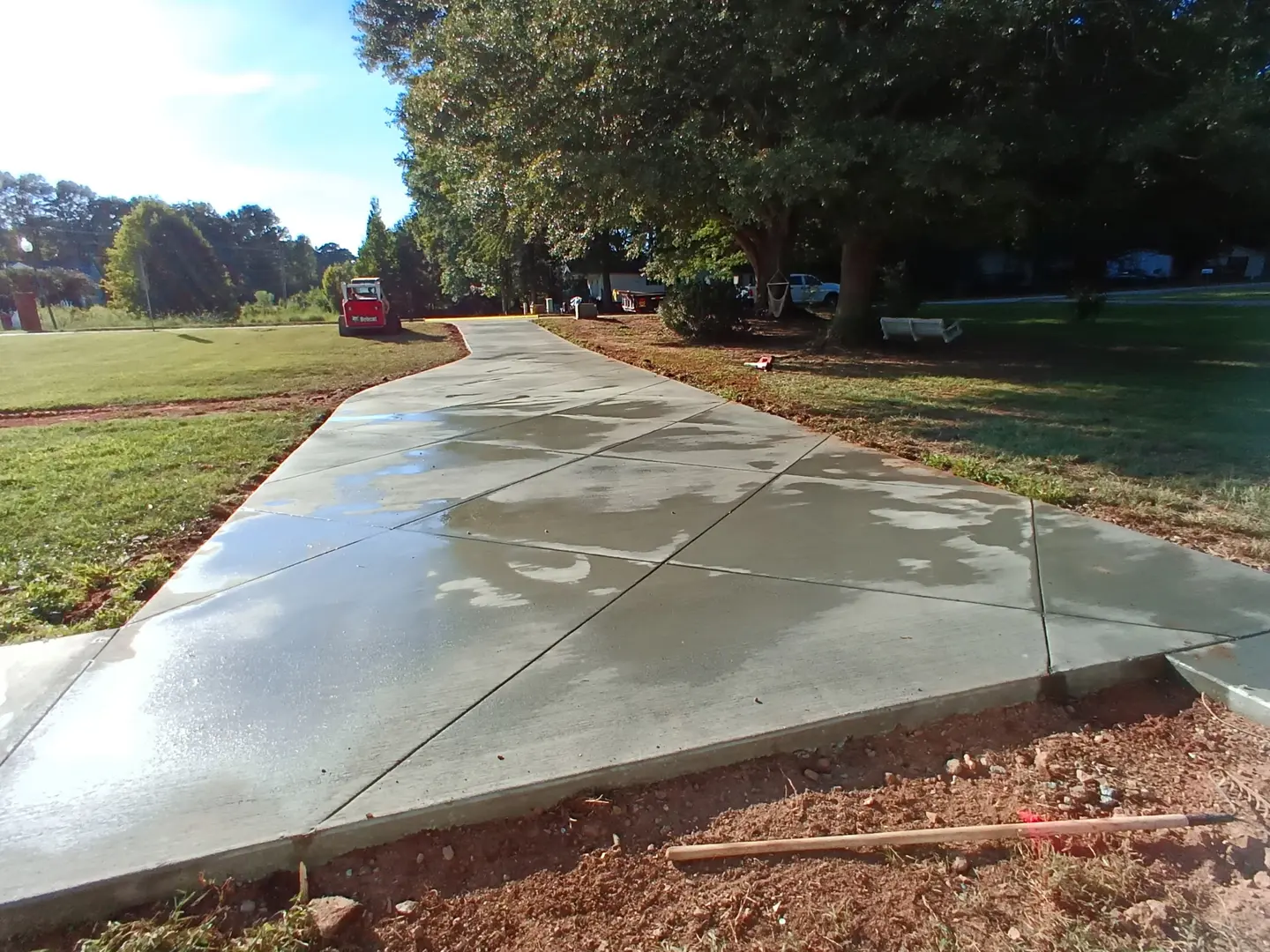 Completed residential concrete approach with clean joints and curved edges
