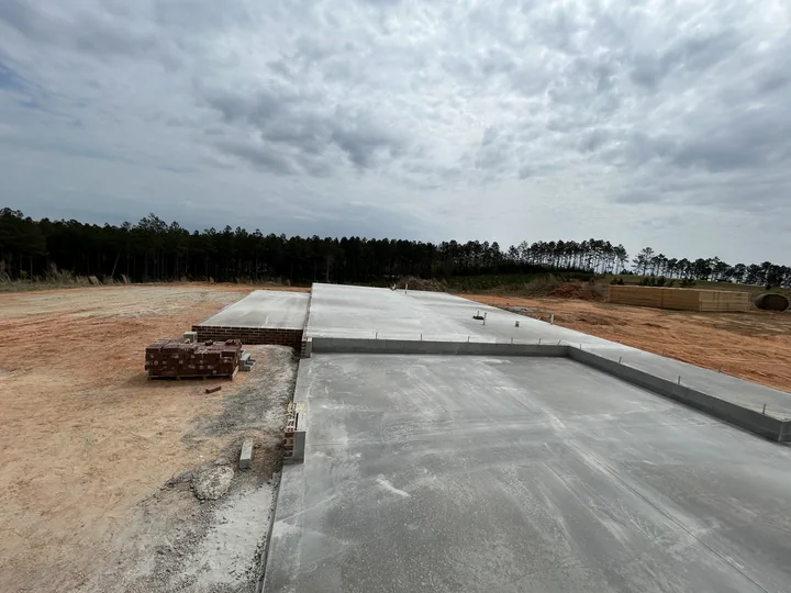 Large finished concrete slab extending across a residential work site