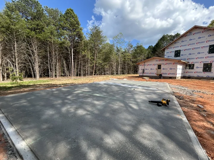Wide residential concrete driveway with a clean finished surface
