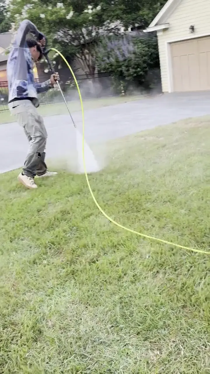 Final rinse and cleanup of a concrete driveway