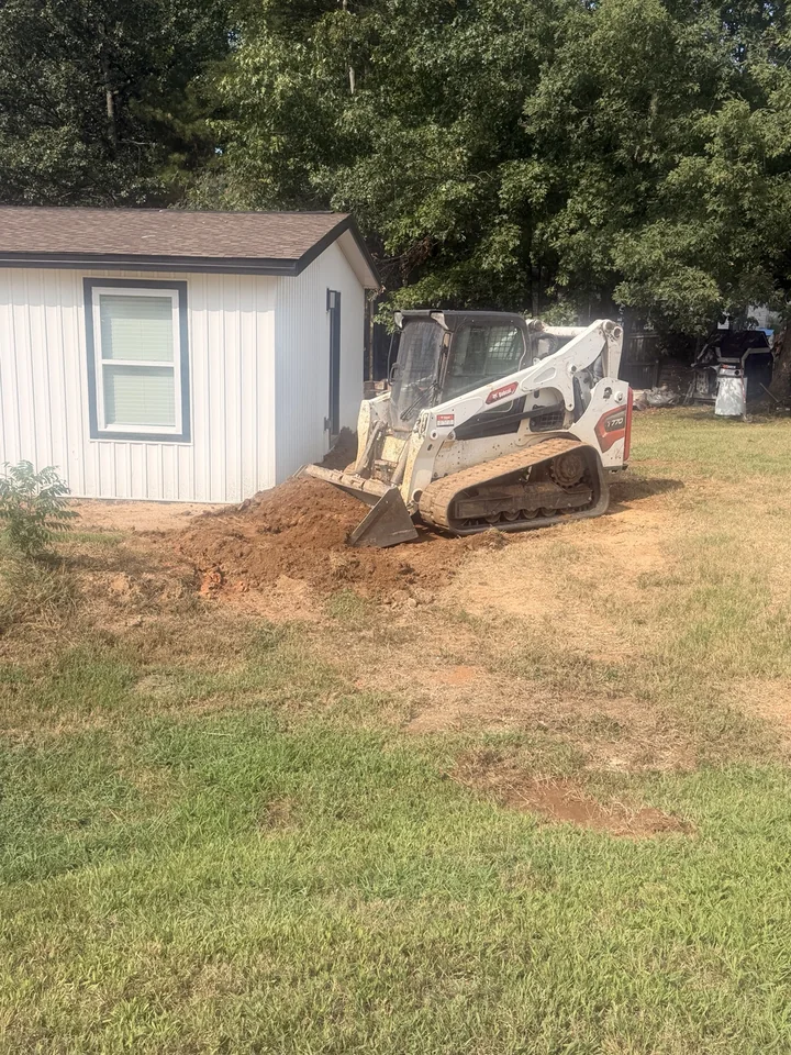 Earthwork beside a building